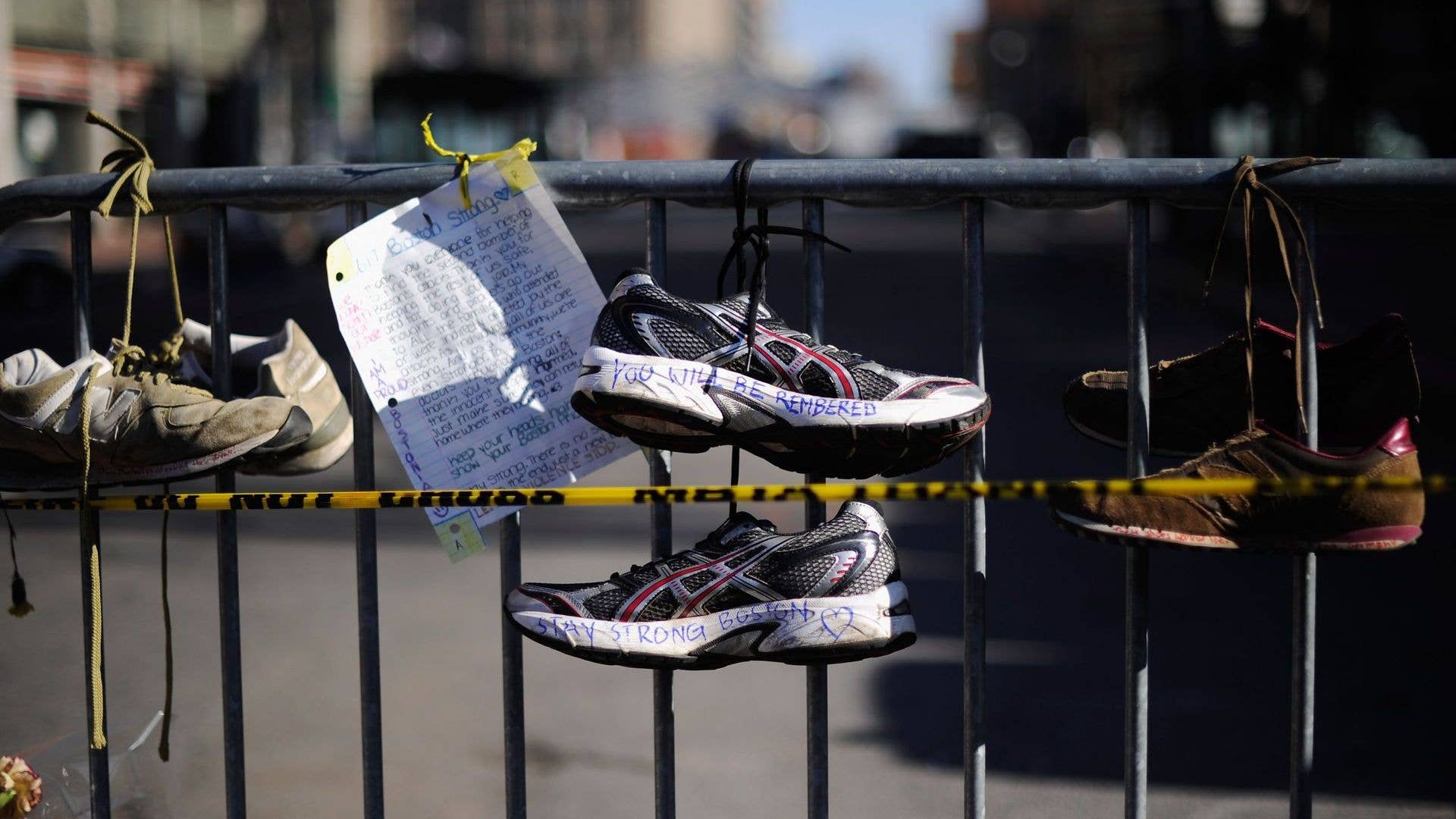 Shoes hang at a Boston Marathon display