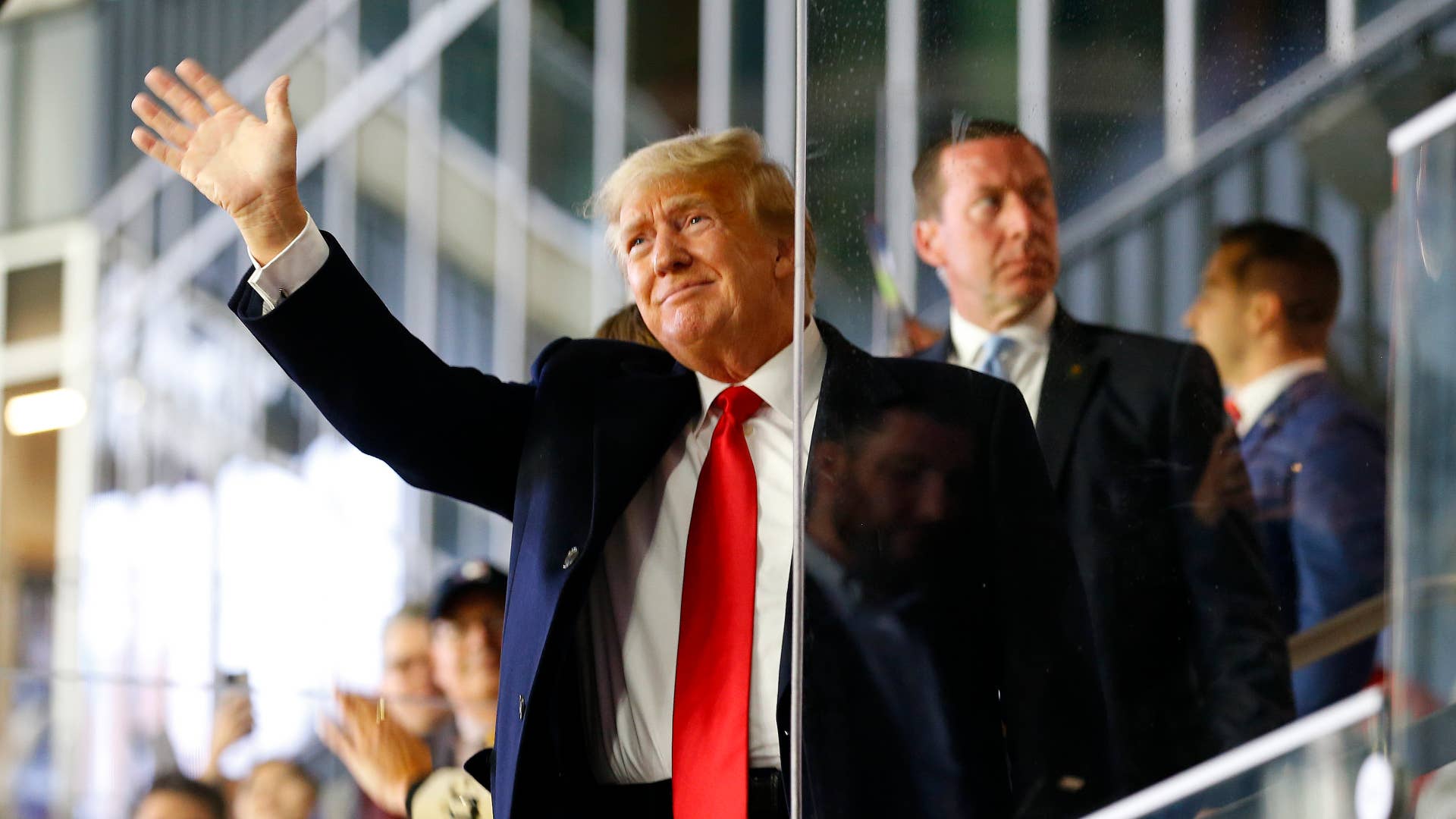 Former POTUS Donald Trump is pictured waving his hand