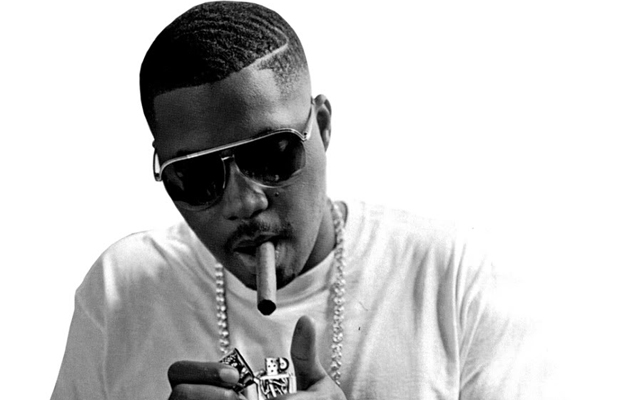 Black and white photo of Nas smoking a cigar