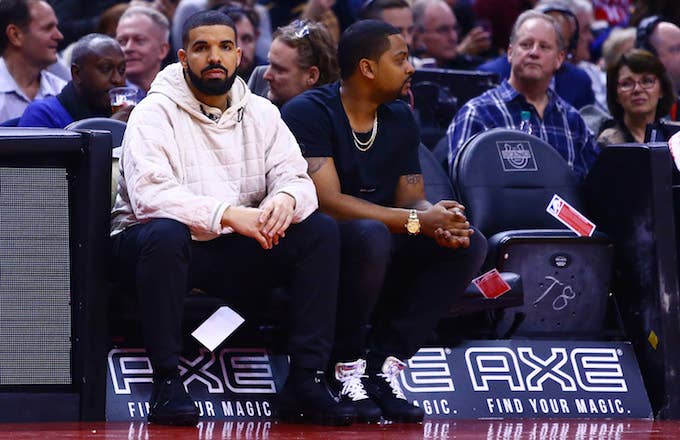 Drake sitting at a Toronto Raptors game.