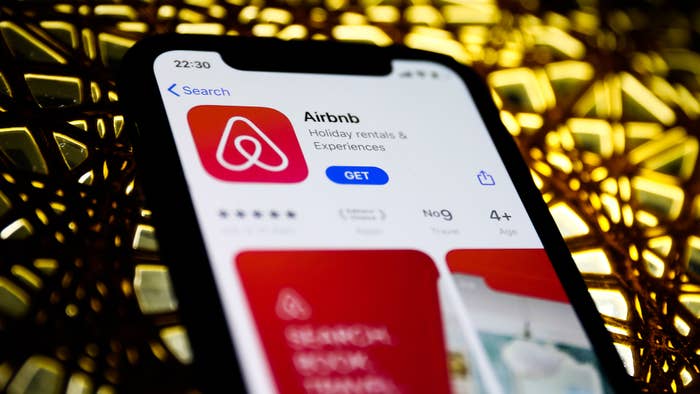 Airbnb logo is seen displayed on a phone screen in this illustration photo