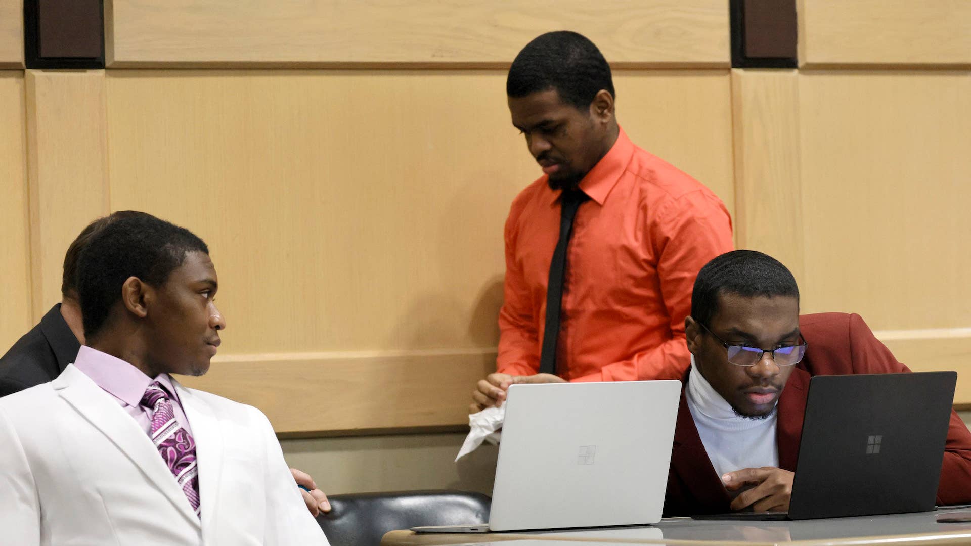 Trayvon Newsome, left, Dedrick Williams, standing, and Michael Boatwright are seen.