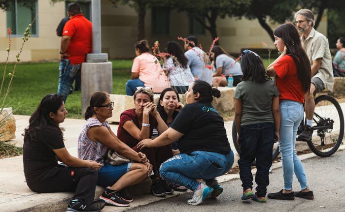 People grieve outside Robb Elementary School on May 24, 2022 in Uvalde, Texas