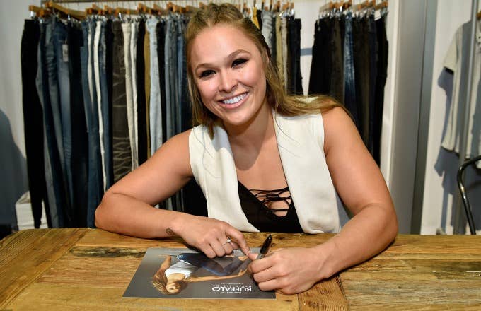 Ronda Rousey signs autographs.