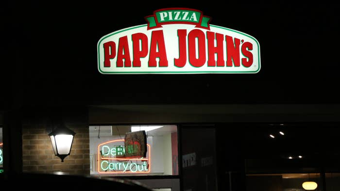 A sign for a Papa Johns pizza shop is shown