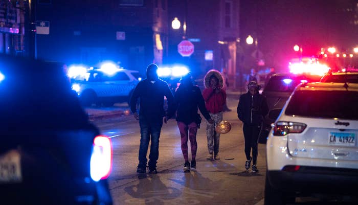 Police investigate the scene where as many as 14 people were shot on Oct. 31, 2022 in Chicago, Illinois