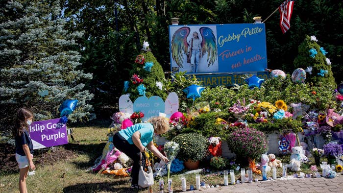 Members of the public leave flowers at a memorial site for Gabby Petito