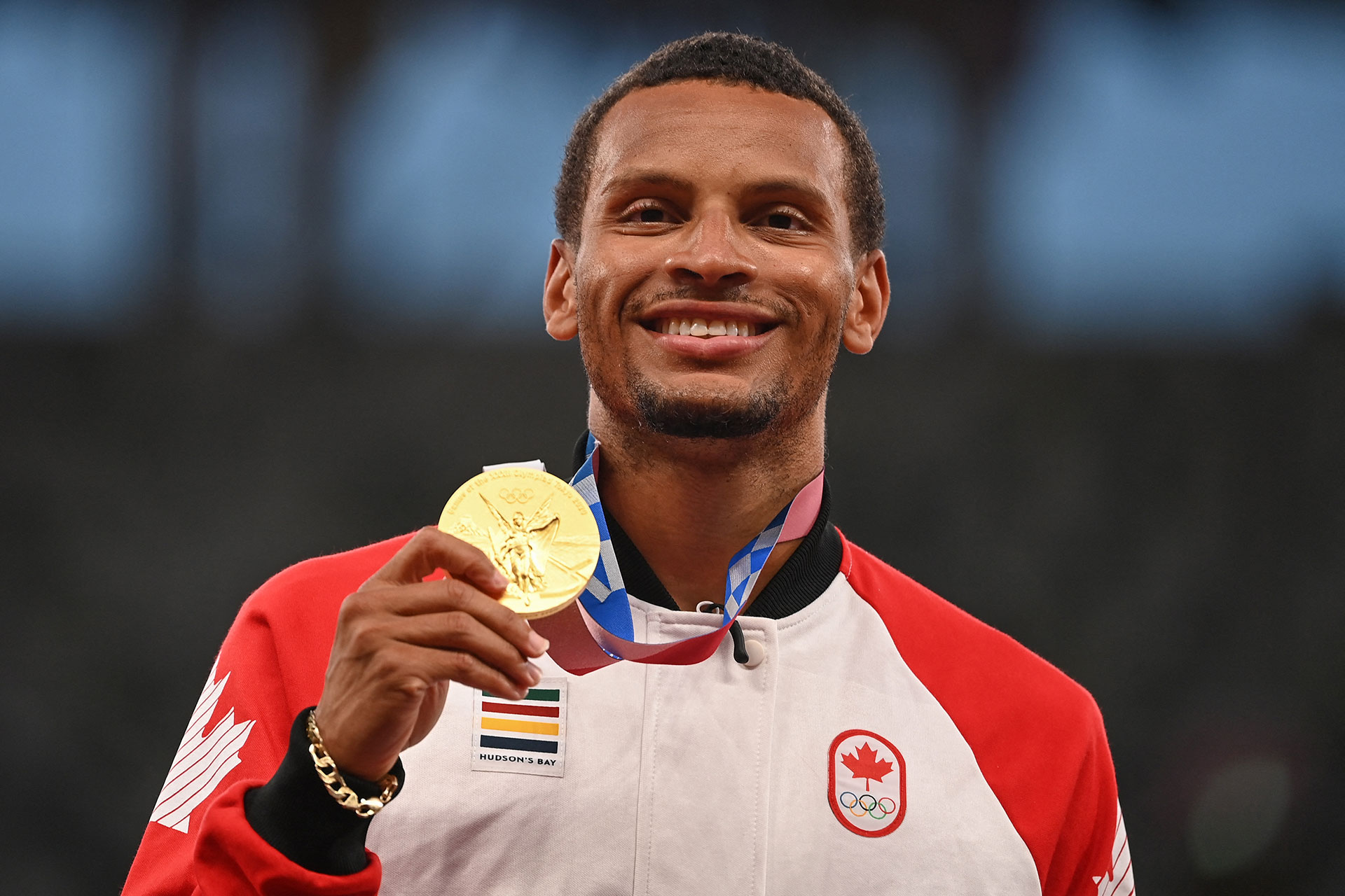 Gold medallist Canada&#x27;s Andre De Grasse poses on the podium after the men&#x27;s 200m