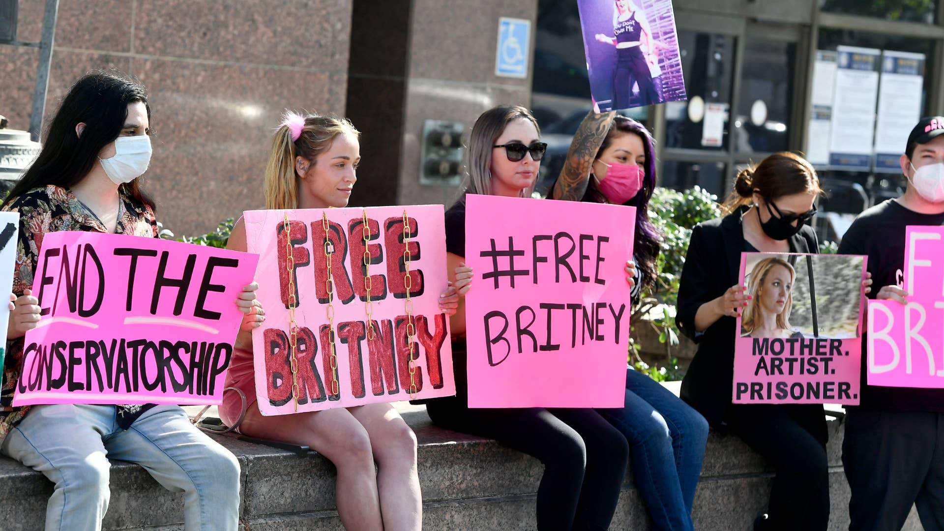Supporters hold signs at the hearing for the Britney Spears Conservatorship.