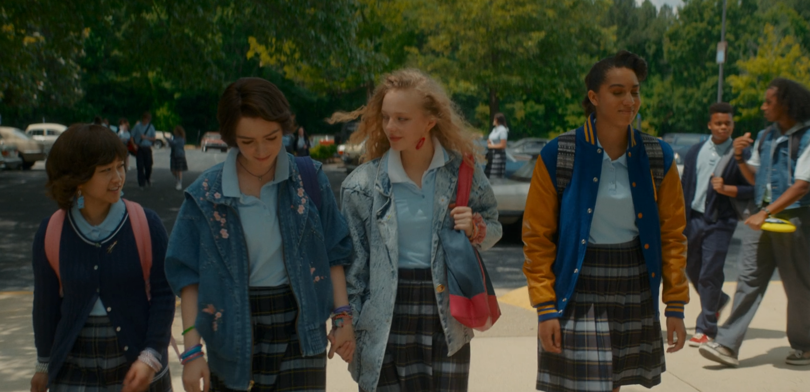 A friend group of girls enter school.