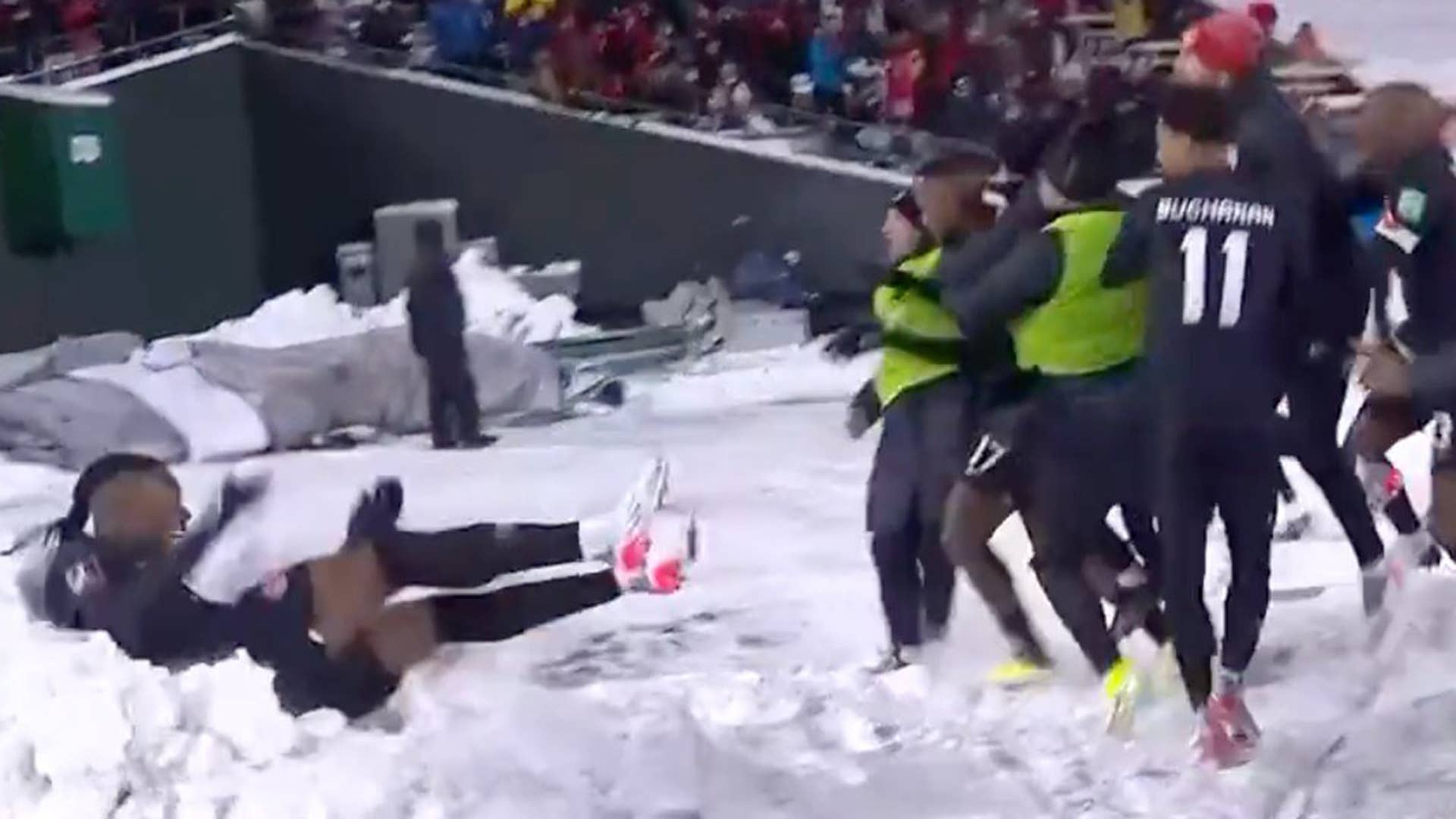 Sam Adekugbe jumps into snowbank in Edmonton following Canadas win against Mexico for World Cup qualifiers.