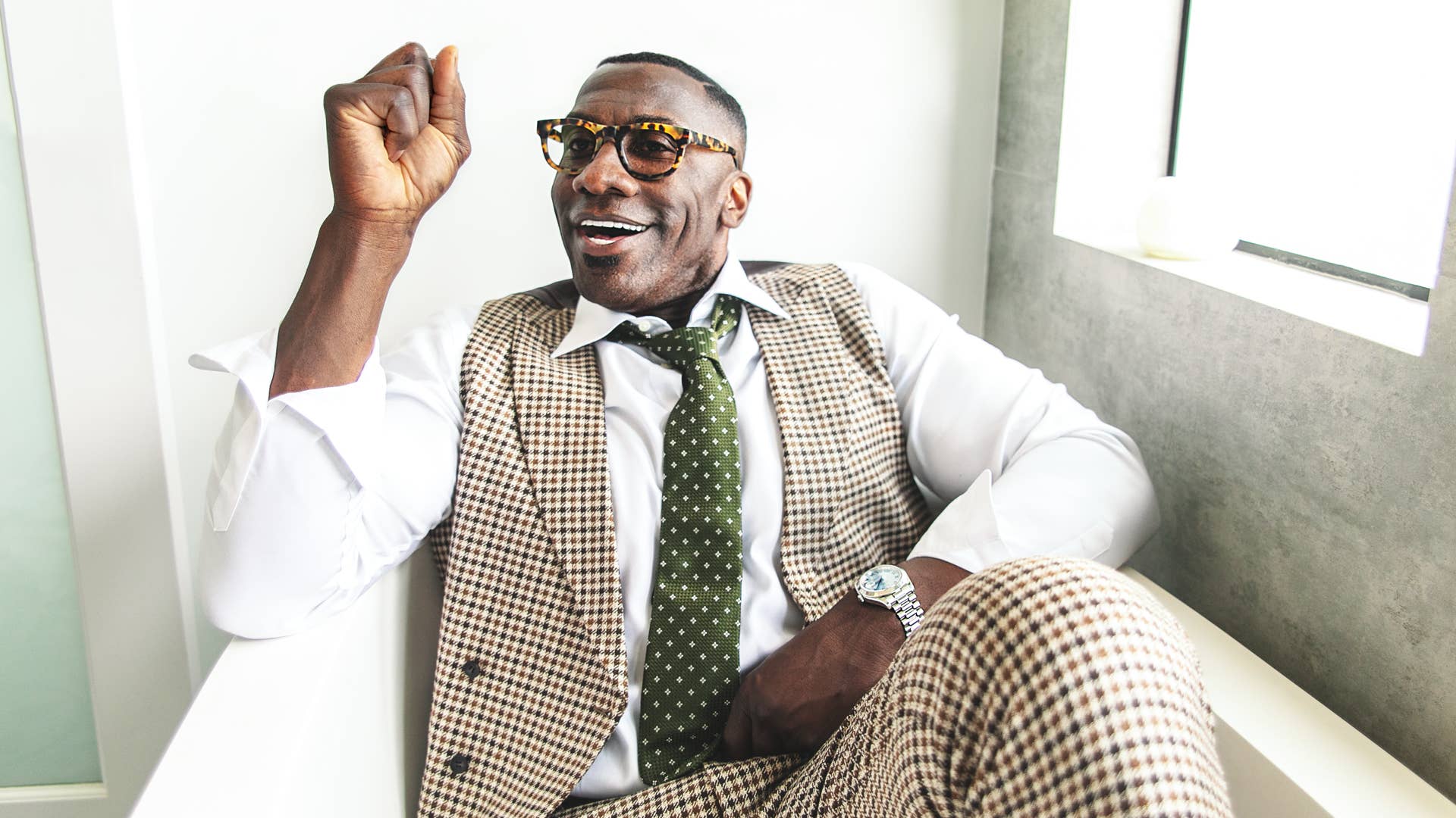 Shannon Sharpe wears a Suit Supply Havana brown houndstooth
