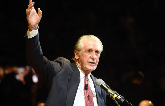 Pat Riley raises his right arm during a ceremony to honor Shaquille O&#x27;Neal