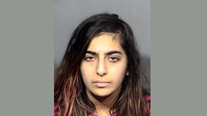 A woman is pictured in a mugshot over a stabbing incident