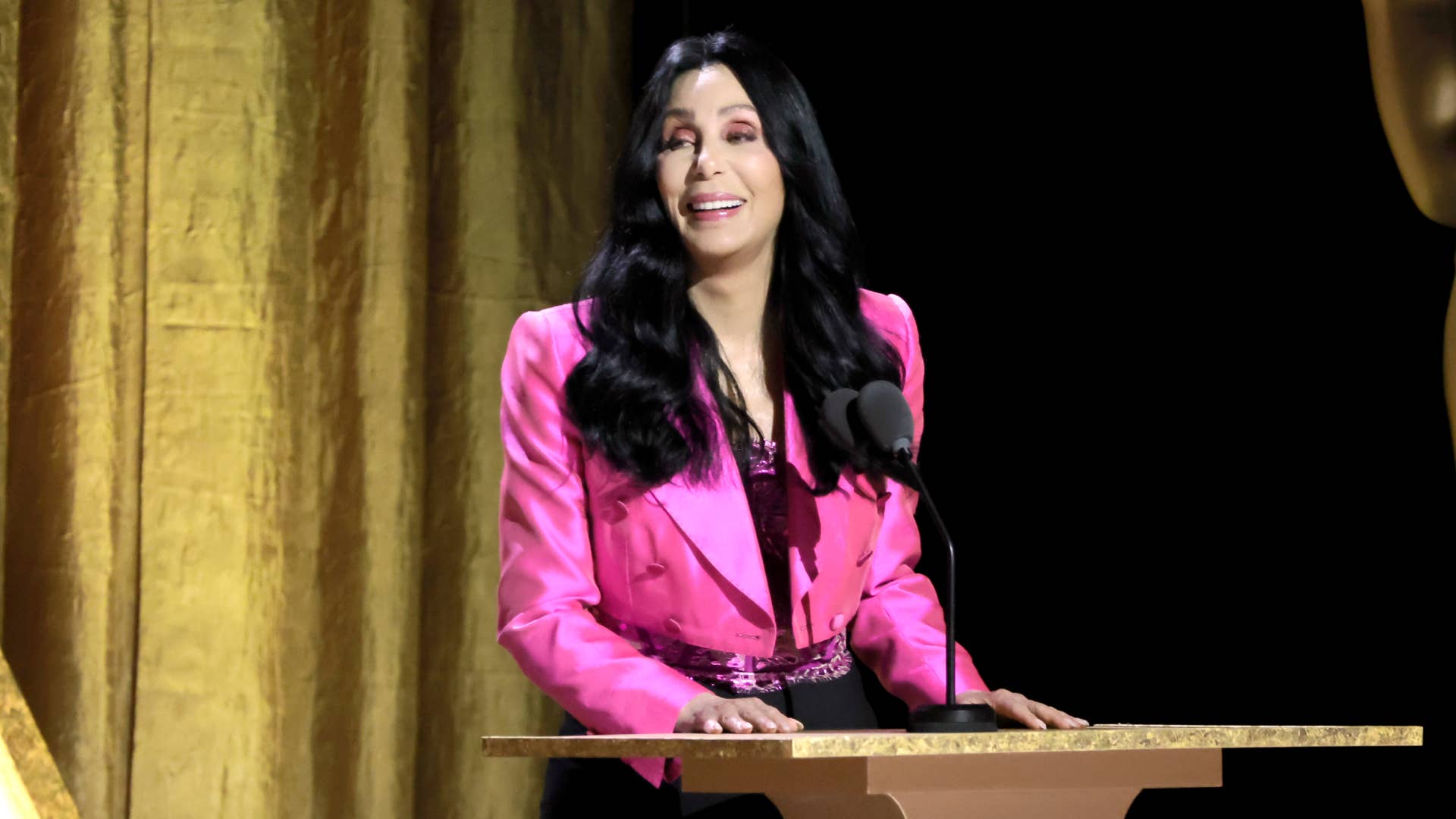 Cher speaks onstage during the Academy of Motion Picture Arts and Sciences