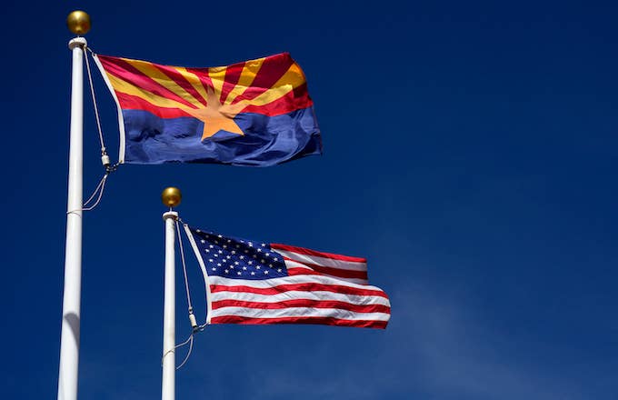 Arizona state flag flies beside the United States flag
