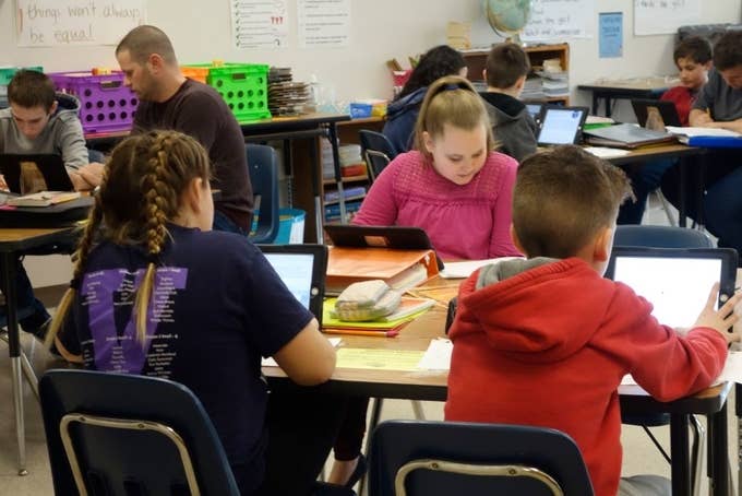 Students and teacher working in a classroom Wellsville, New York