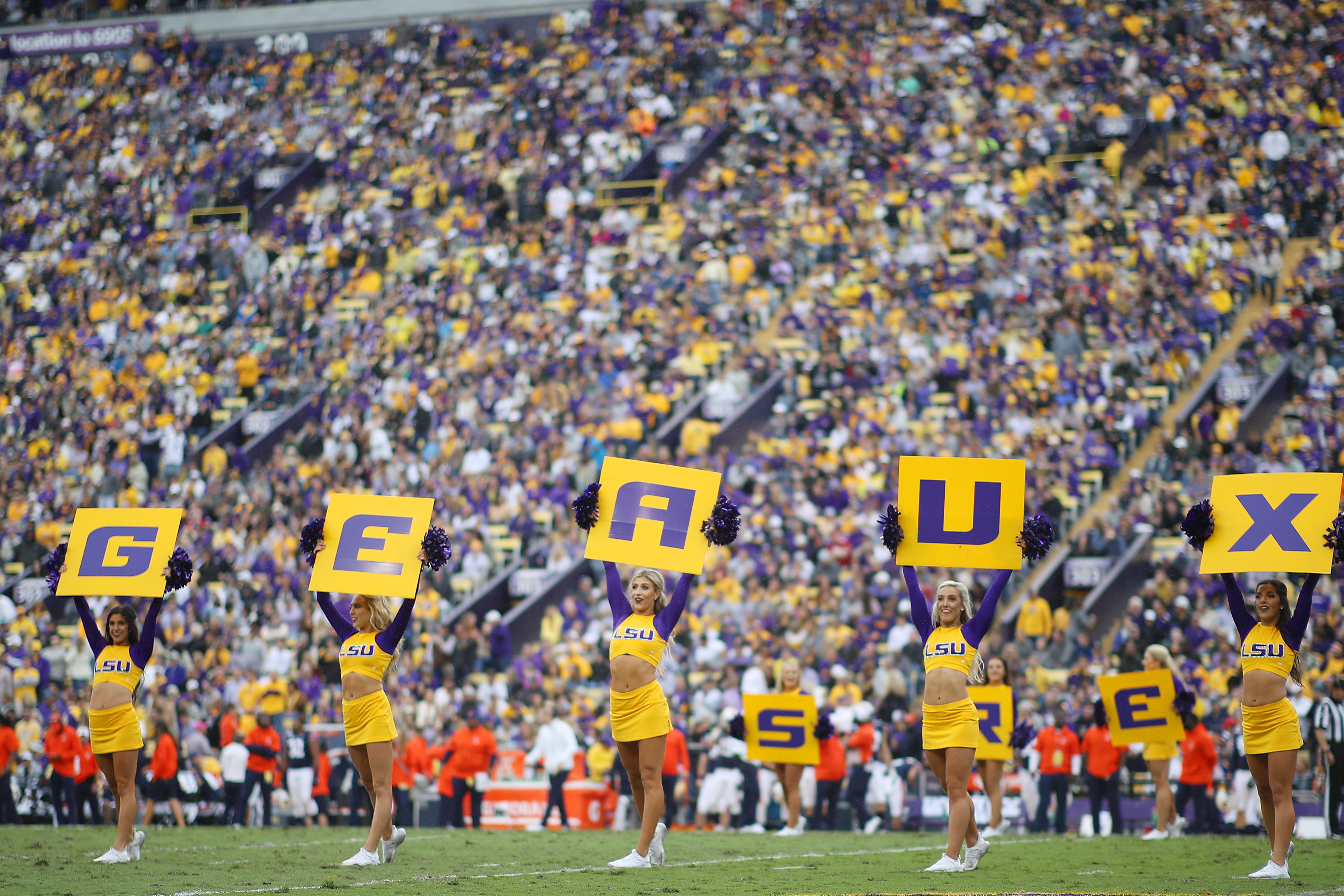 LSU cheerleaders on football field spelling out &quot;GEAUX&quot;