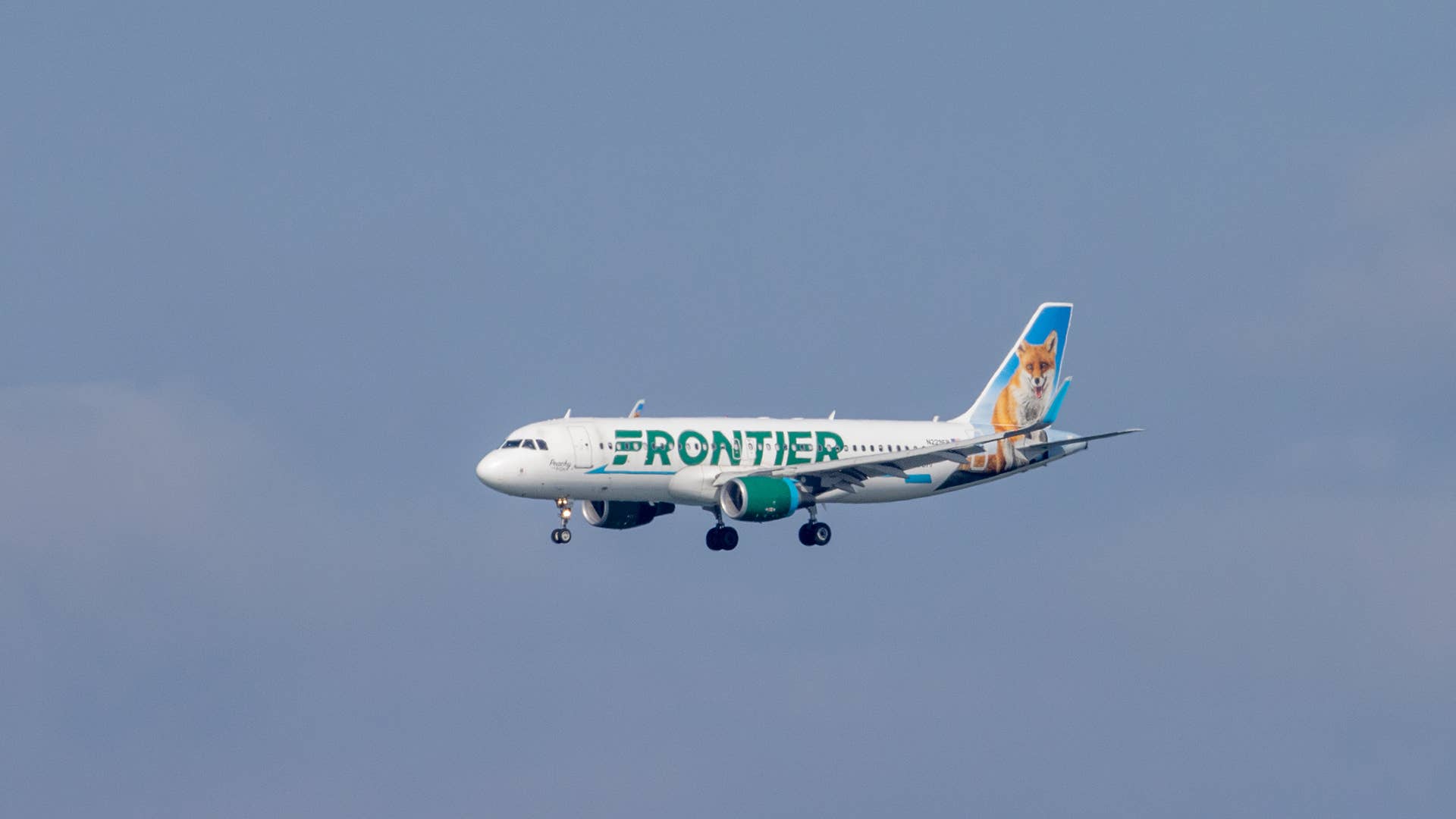 A Frontier Airlines plane lands at San Francisco International Airport