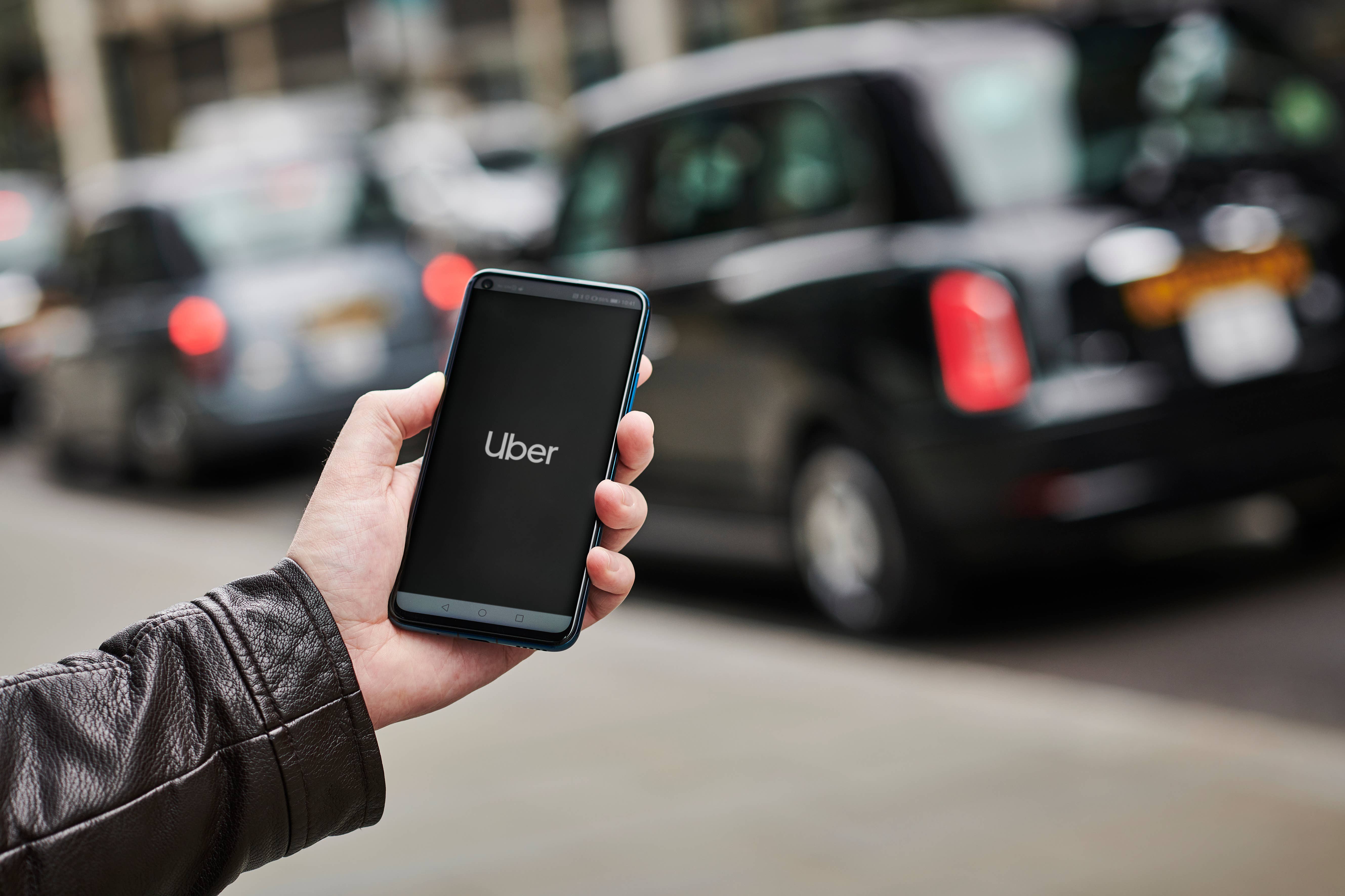 person holding phone with uber