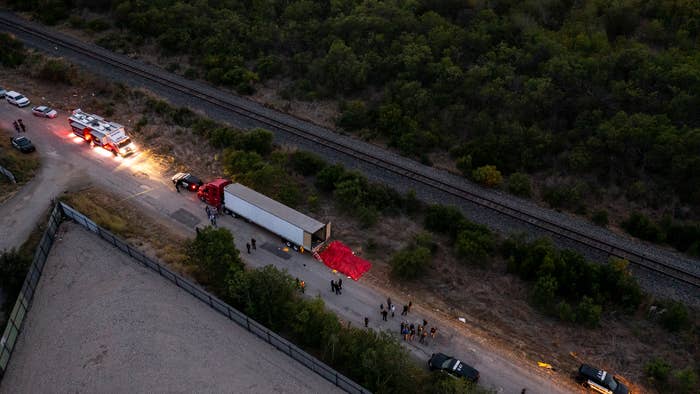 In this aerial view, members of law enforcement investigate a tractor trailer