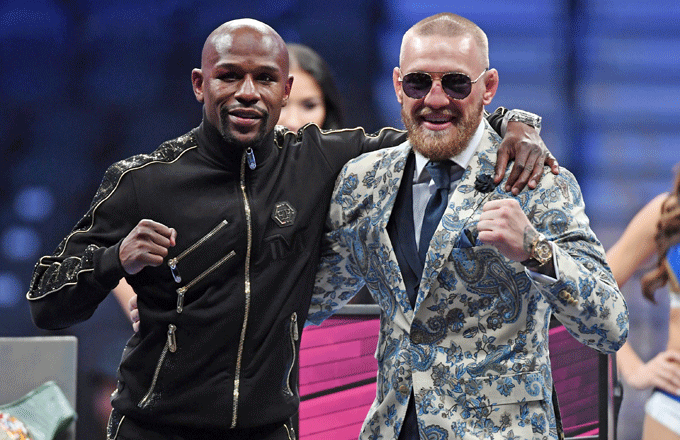 Floyd Mayweather poses alongside Conor McGregor.