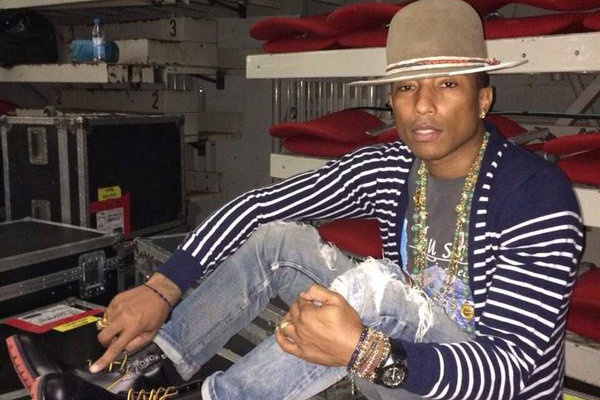 Pharrell Williams sitting on top of road cases