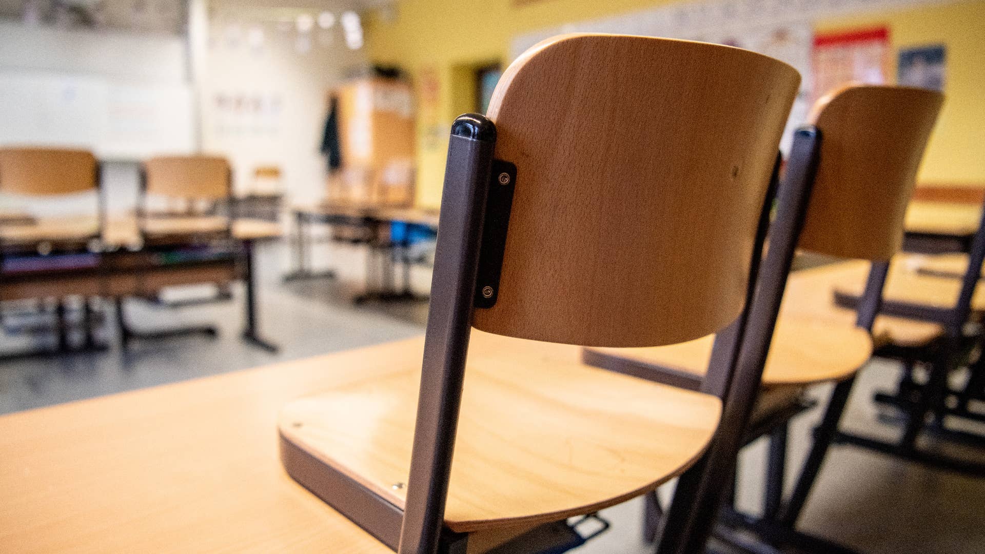 Chairs are placed on the tables in a classroom in a primary school.
