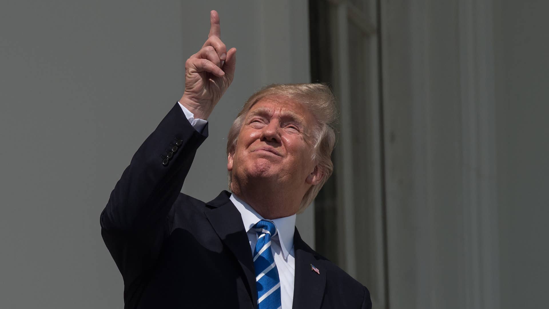 Donald Trump looks up at the partial solar eclipse.