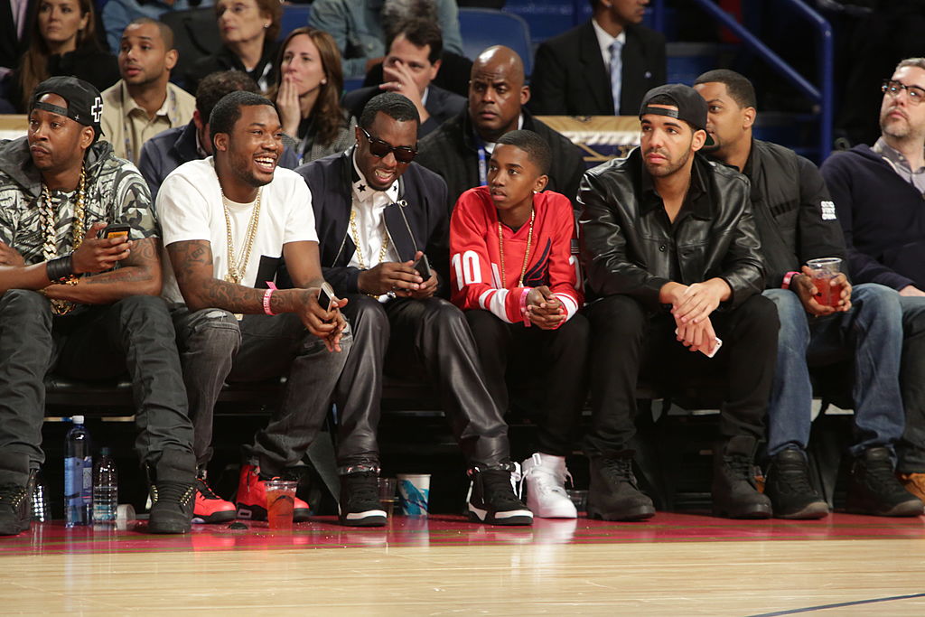 Meek Mill, Drake and others at a basketball game.