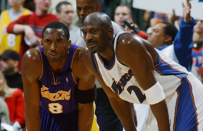 Kobe Bryant #8 of the Los Angeles Lakers rests next to Michael Jordan