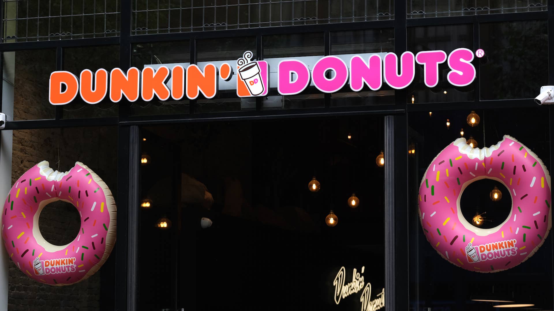 A logo of Dunkin' Donuts is seen at the entrance of its store