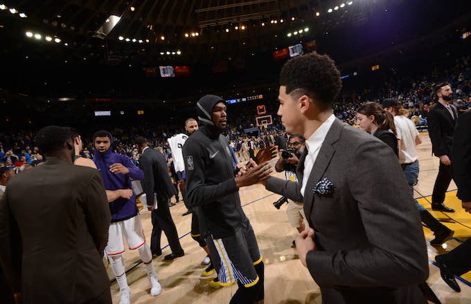 Kevin Durant and Devin Booker shake hands after the game.