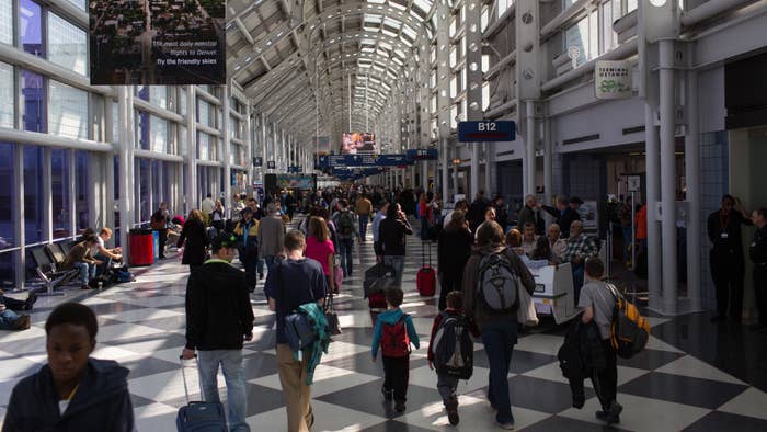 Traveling passengers walk to their flights at Chicago&#x27;s O&#x27;Hare International Airport.
