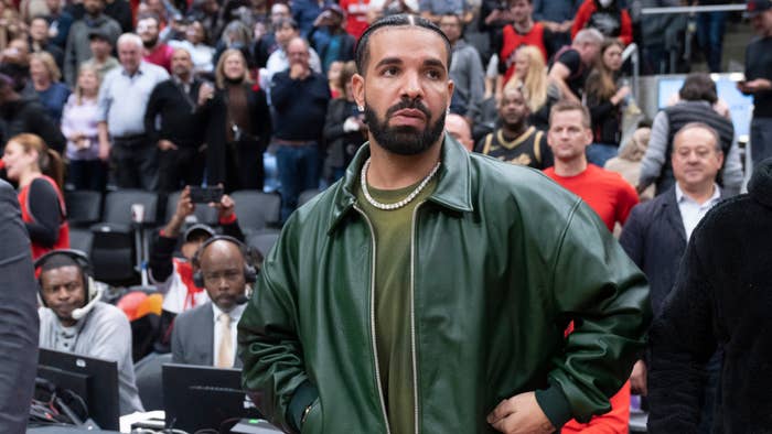 Drake gets up from his seat after the Toronto Raptors defeated the Chicago Bulls at the Scotiabank Arena