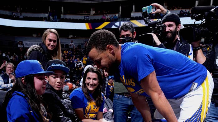 Stephen Curry #30 of the Golden State Warriors greets young fan, P.J. OBrien
