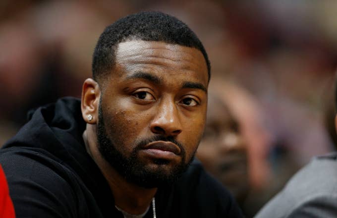 John Wall #2 of the Washington Wizards looks on from the bench
