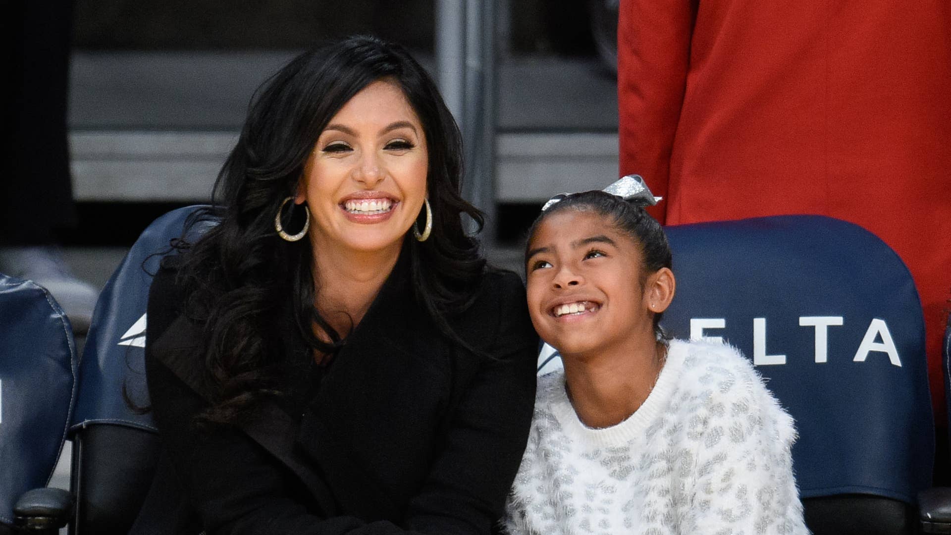 Vanessa Bryant and Gianna Bryant attend a basketball game.