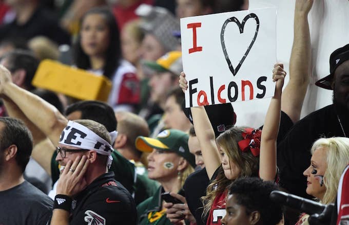 Atlanta Falcons fans in Georgia Dome raise their signs.