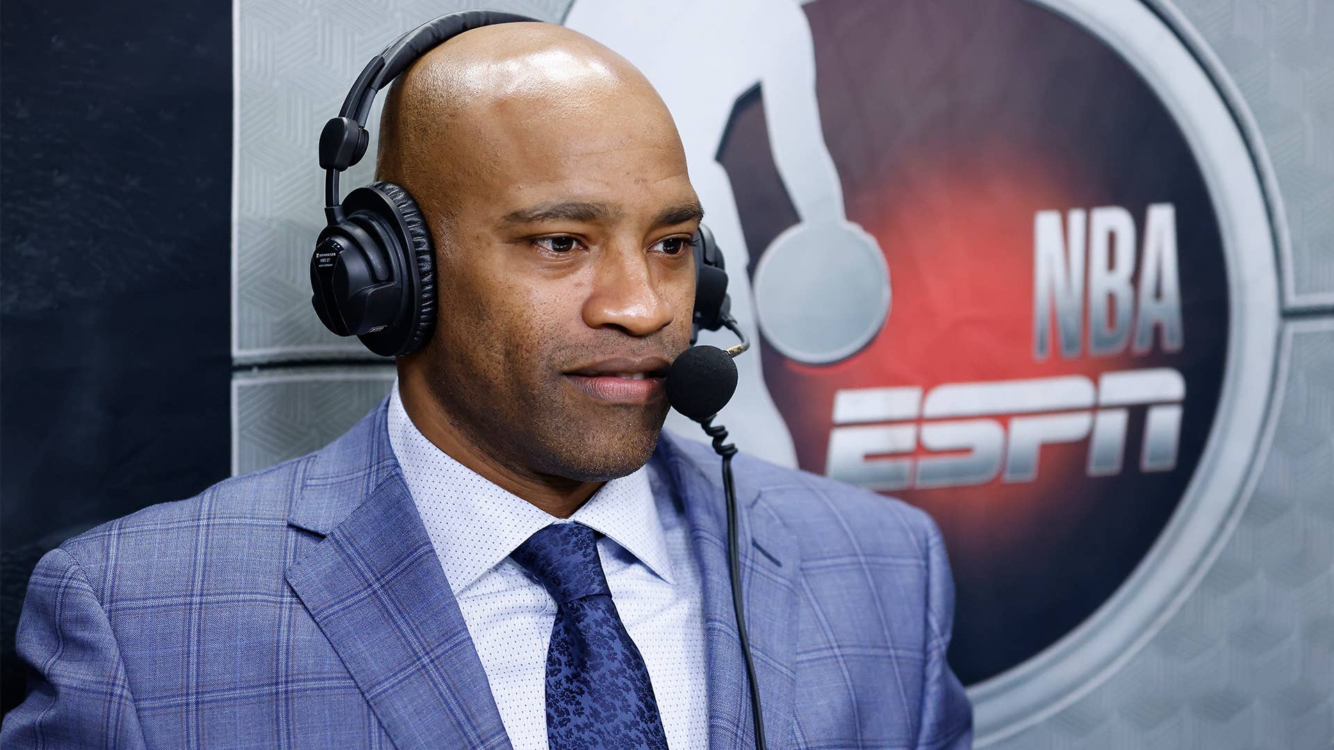 Vince Carter in a suit broadcasting