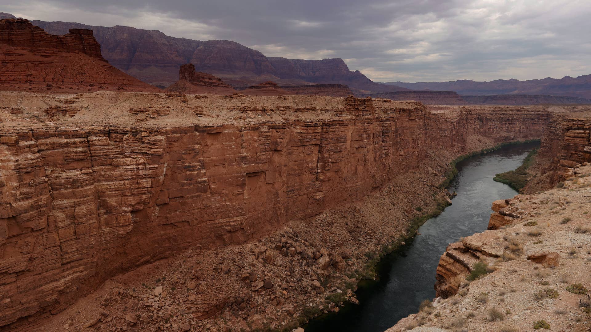 The Colorado River flows by the historic Navajo Bridge.
