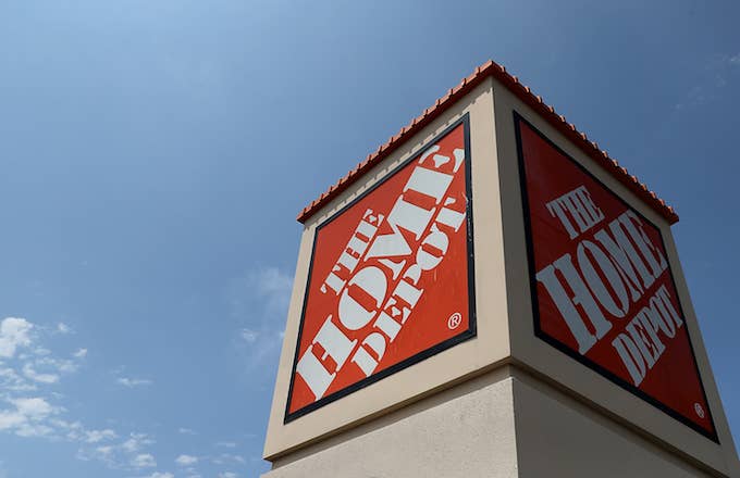 A sign is posted in front of a Home Depot store.