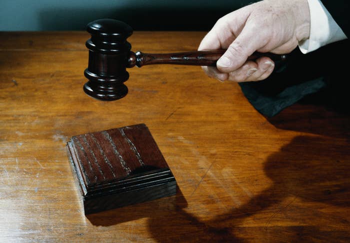 Judge hitting a gavel in a courtroom