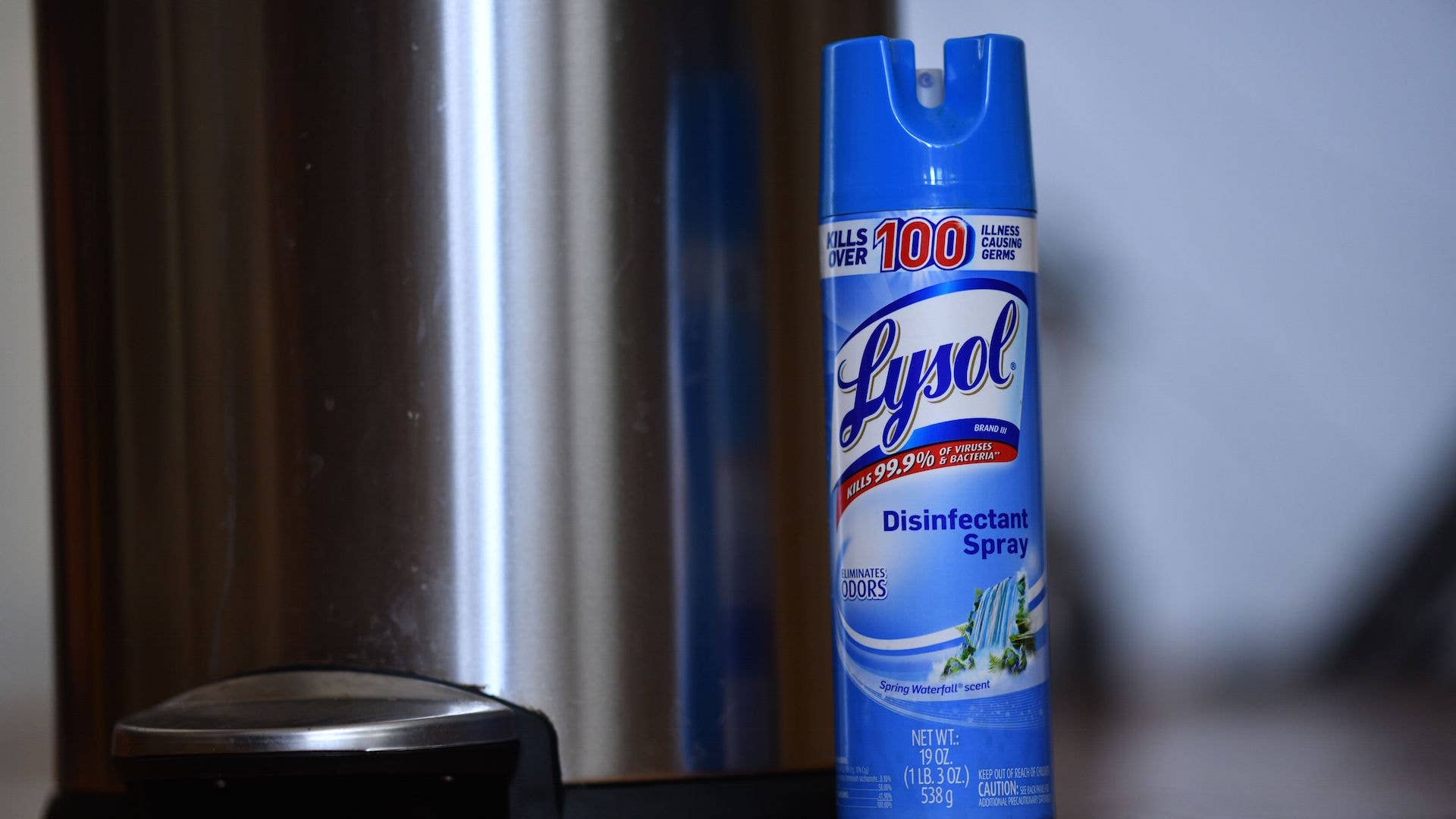 Lysol disinfectant spray next to a trash can