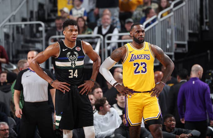 Giannis Antetokounmpo and LeBron James look on during a game.