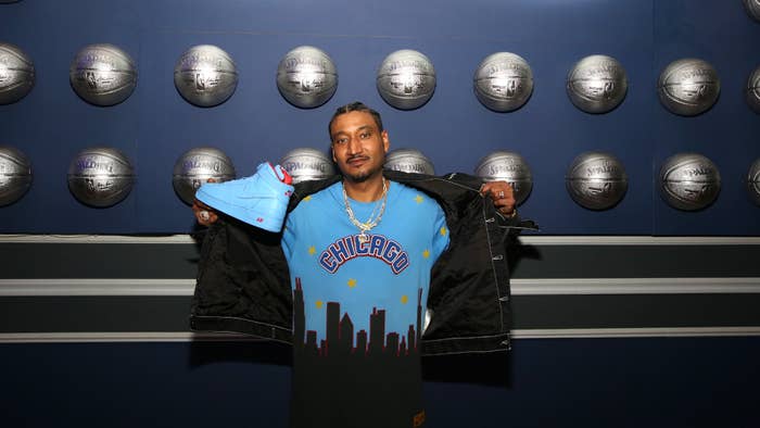Don C is pictured holding up a shoe at an event