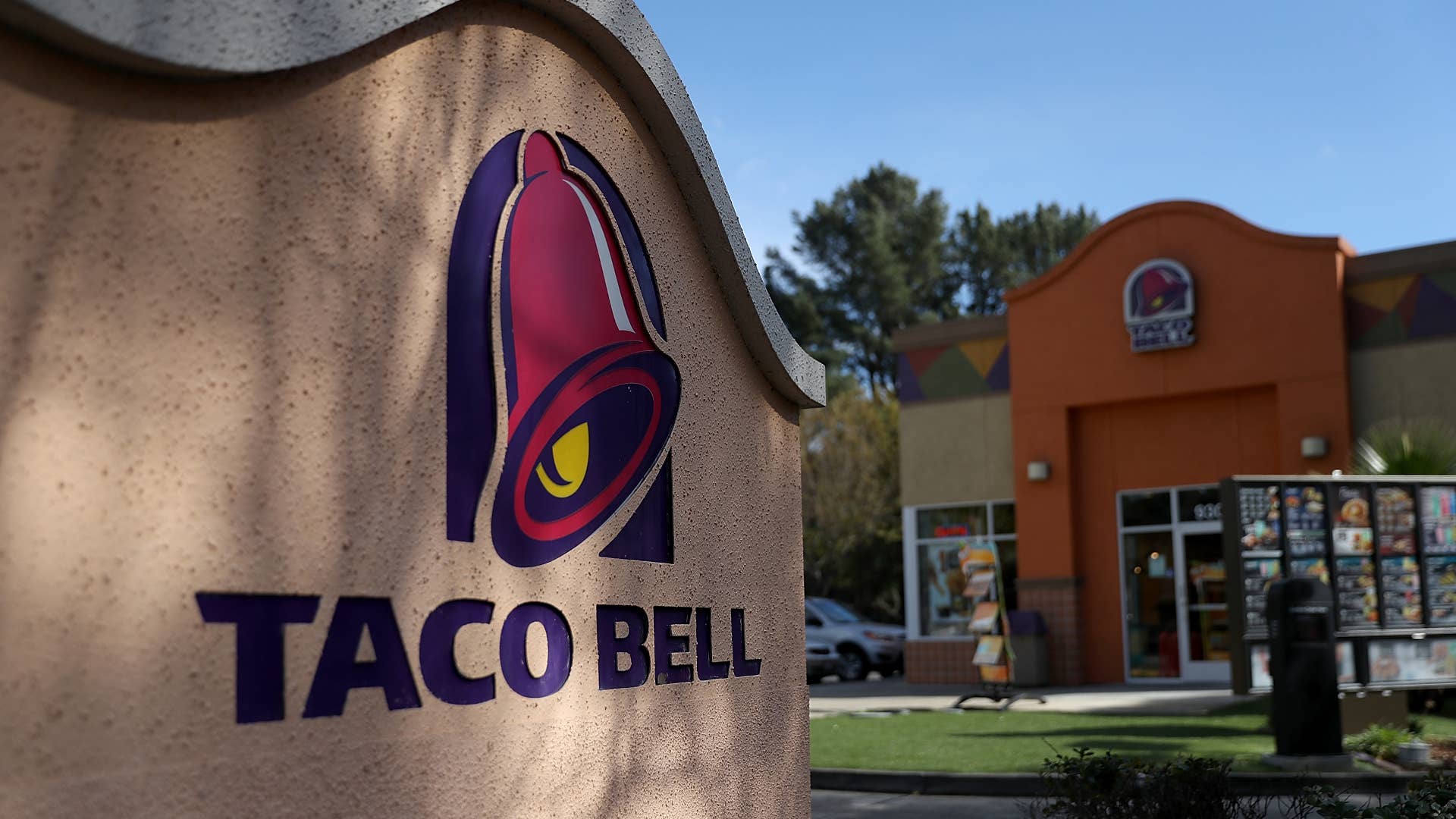 A sign is posted in front of a Taco Bell restaurant.