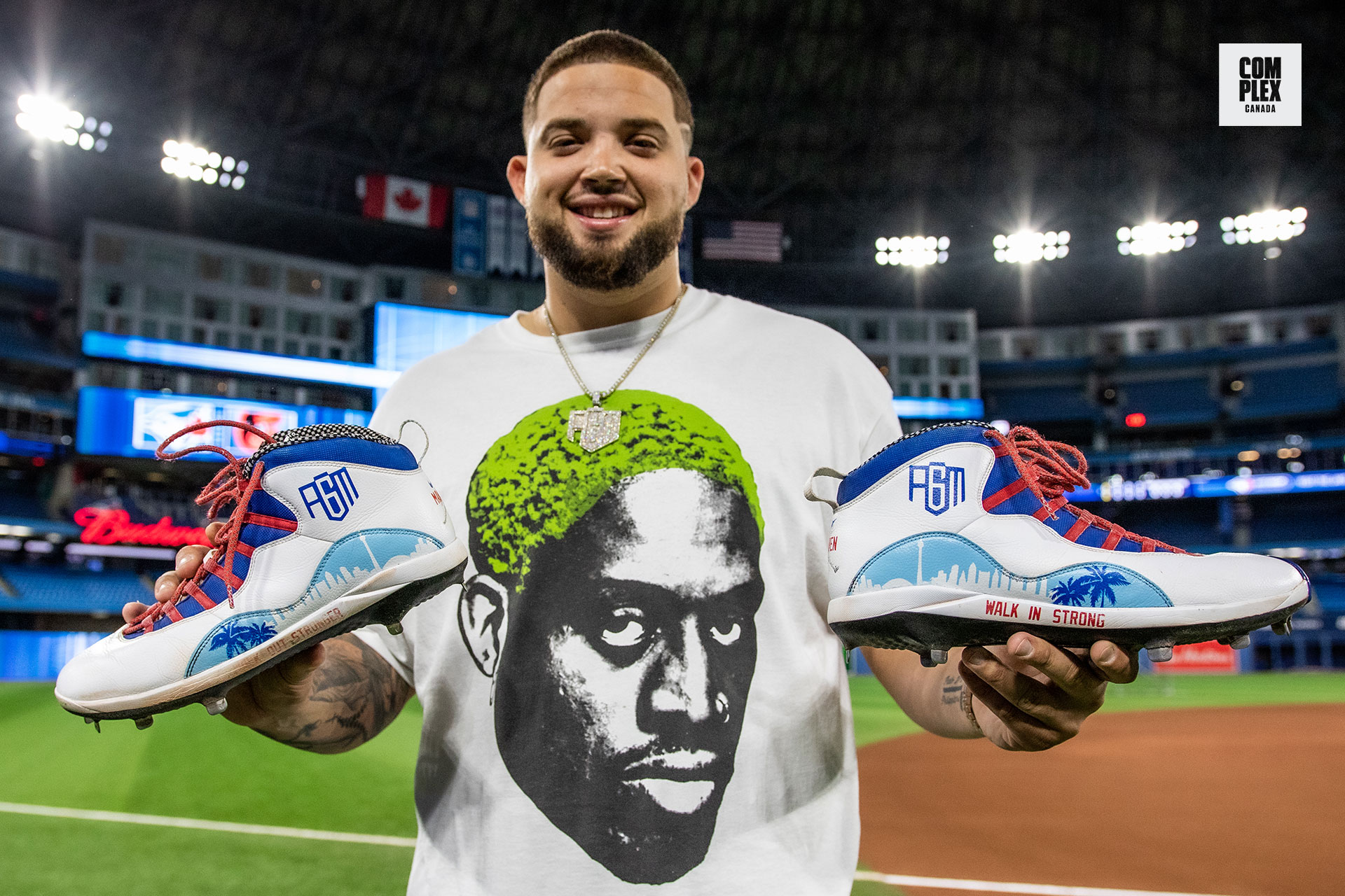 Toronto Blue Jays&#x27; Alek Manoah holding up his custom sneakers