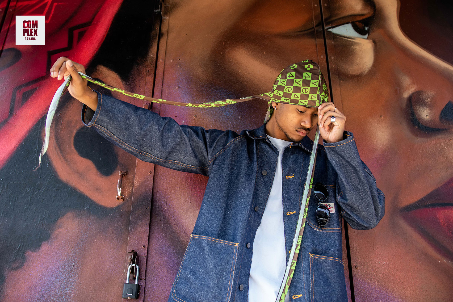 Dylan Sinclair poses against mural