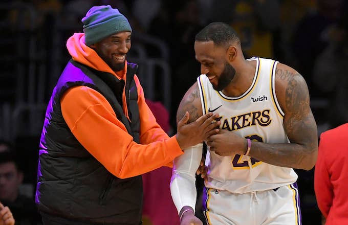 LeBron James has a moment on the sideline with former Laker Kobe Bryant.